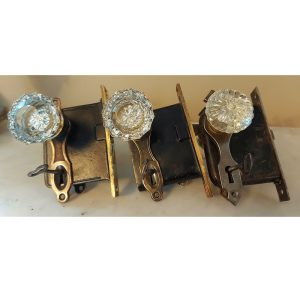 three brass door locks with glass handles